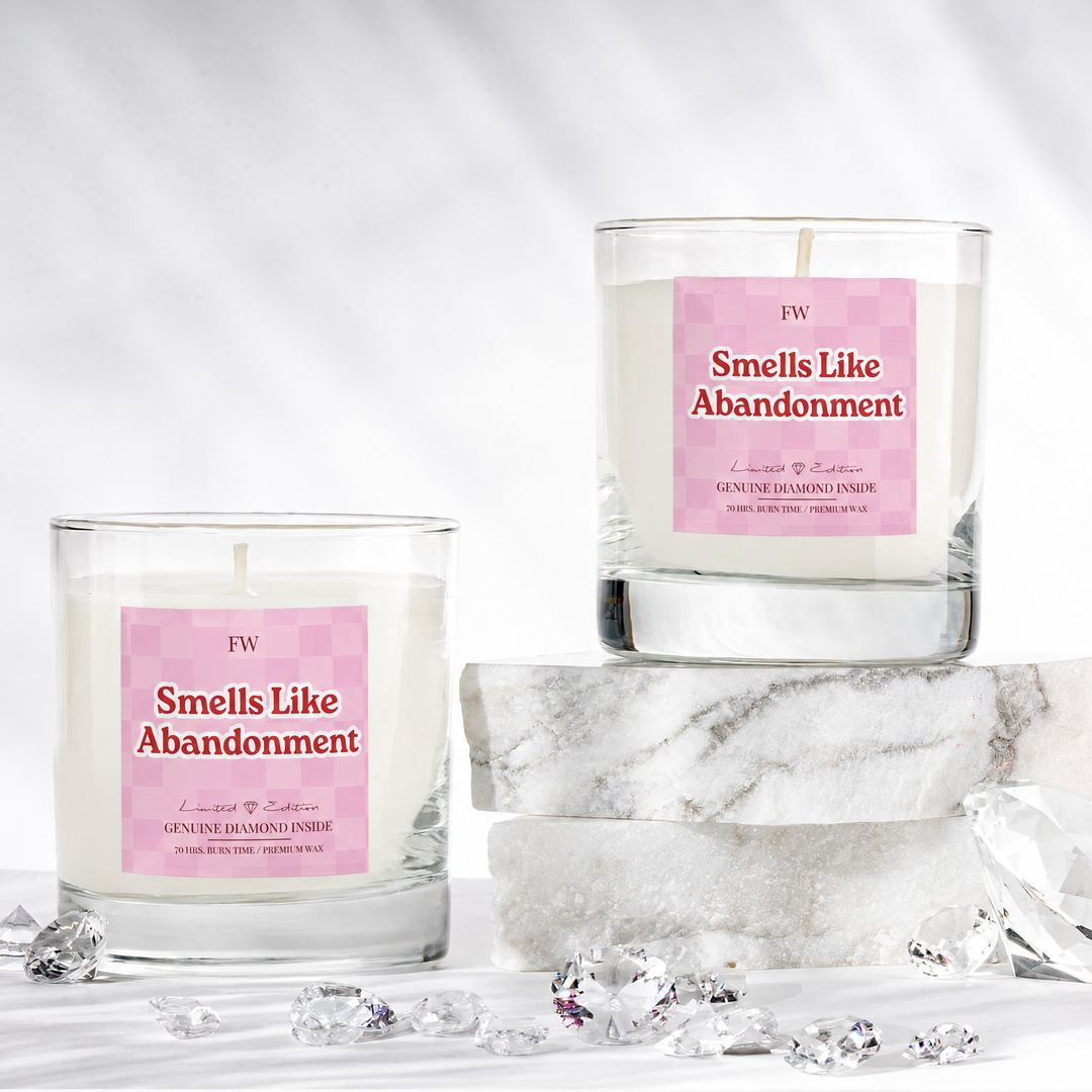 Two Smells Like Abandonment Diamond Candles with loose diamonds on marble