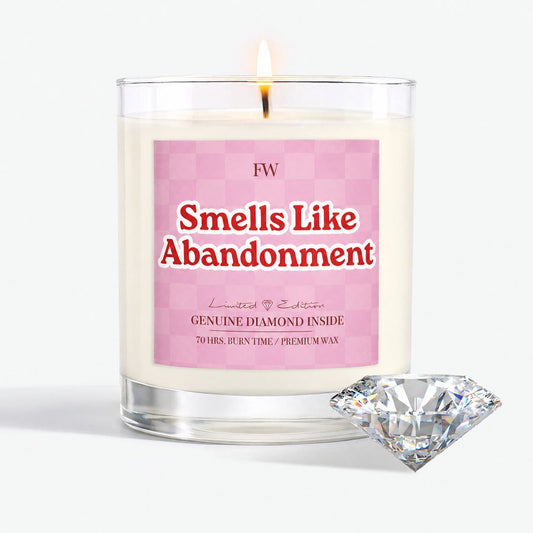 Smells Like Abandonment Diamond Candle lit, with a genuine diamond beside it
