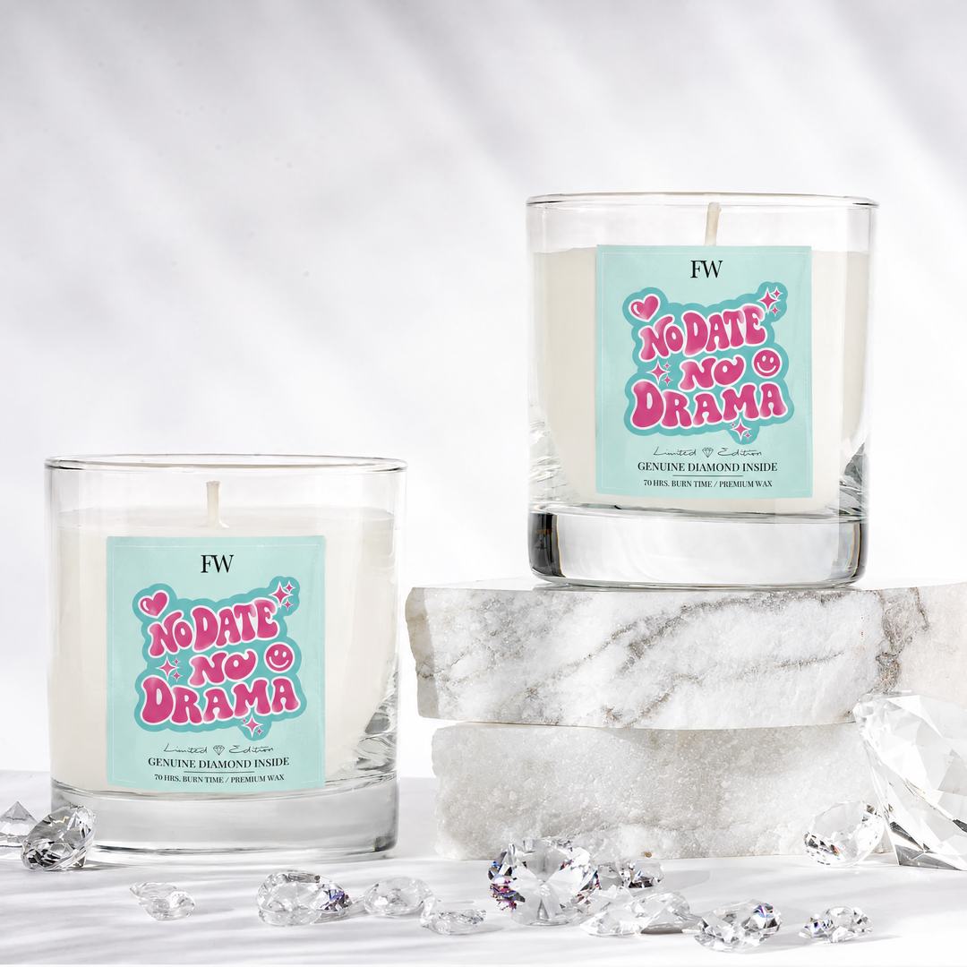 Two No Date No Drama Diamond Candles with loose diamonds on marble
